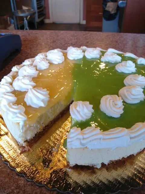 Cheesecake with whipped cream rosettes and glaze