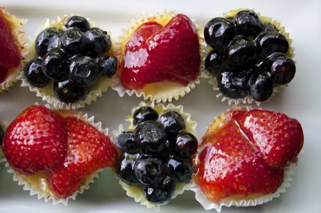 Mini fruit cheesecakes topped with berries
