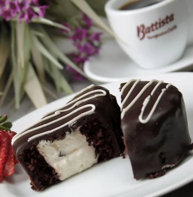 Chocolate-glazed pastries with white chocolate drizzle