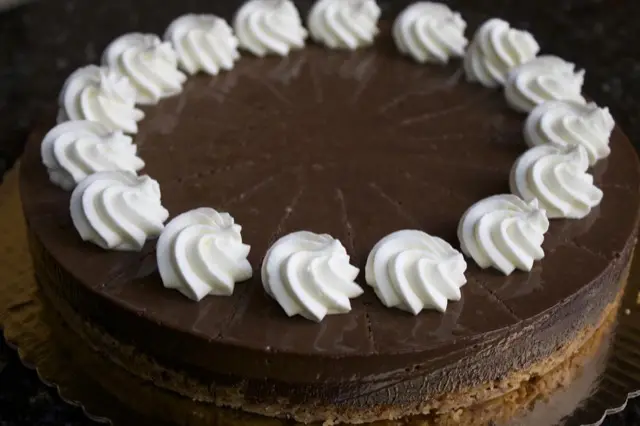 Chocolate toffee torte ringed with whipped cream